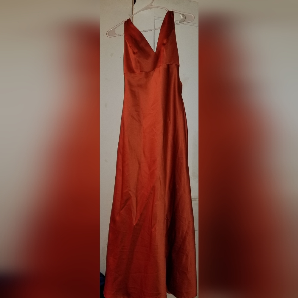 Formal dress, size 6, burnt orange color with rhinestone on the back.